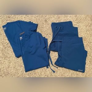 Grey’s anatomy nursing scrubs - 2 tops & 2 bottoms. Color royal blue, size XS.